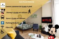 a living room with a bed and a room with a poster at Cocoon 2 Proche - Disney Paris- Parking gratuit in Serris