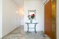 a vase of flowers on a table in a hallway at ELEGANCE YourHostHelper in Le Cannet