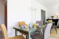 a dining room with a green table and chairs at ELEGANCE YourHostHelper in Le Cannet