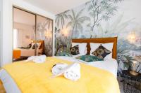 a bedroom with a yellow bed with towels on it at ELEGANCE YourHostHelper in Le Cannet