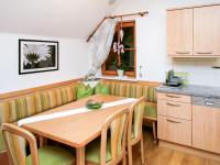 a kitchen and dining room with a wooden table at Apartment Poldi by Interhome in Haus im Ennstal