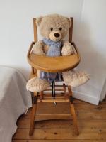 a teddy bear sitting in a wooden chair at LA P&#39;TITE YPORTAISE in Yport