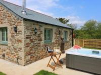a stone house with a hot tub in front of it at Omalast in Truro