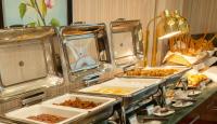 a buffet with several trays of food on a table at City Tower Hotel in Kuwait