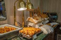 a buffet with pastries and other food on a table at City Tower Hotel in Kuwait