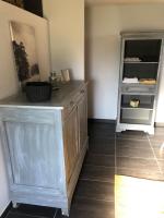 a room with a wooden cabinet and a shelf at Les Vieille tuiles in Cudos