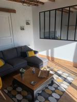 a living room with a couch and a coffee table at Les Vieille tuiles in Cudos