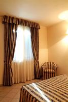 Łóżko lub łóżka w pokoju w obiekcie Hotel La Maddalena
