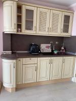 a kitchen with white cabinets and a counter top at SPA Apartament Sirius house in Saints Constantine and Helena