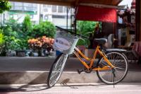 an orange bike with a basket parked on a sidewalk at Chiayi King Hotel in Chiayi City