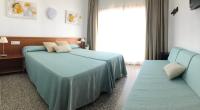 Łóżko lub łóżka w pokoju w obiekcie Hotel Sur