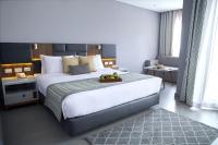 A bed or beds in a room at Sunrise Diamond Beach Resort -Grand Select