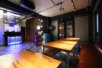 a row of wooden tables in a room at Ji Ye Jing Zhan B&amp;B in Ji&#39;an