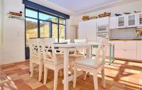 a kitchen with a white table and chairs at Nice Home In Verfeuil With Wifi, Private Swimming Pool And Outdoor Swimming Pool in Verfeuil