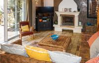 a living room with a couch and a fireplace at Lovely Home In Roujan With Outdoor Swimming Pool in Roujan