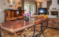a dining room with a table and chairs and a couch at Lovely Home In Roujan With Outdoor Swimming Pool in Roujan
