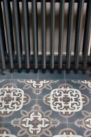 a room with a radiator and a tile floor at Kermaria Studio Suite in Pont-Aven