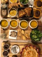 a table filled with different types of food in bowls at Les 3 échoppes in Chargé