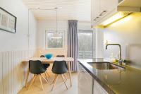 a kitchen with a table and chairs and a sink at Hello Zeeland - Appartement Beatrixstraat 27 in Domburg