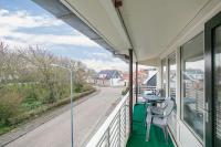 a balcony with a table and chairs on a street at Hello Zeeland - Appartement Beatrixstraat 27 in Domburg