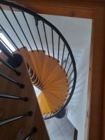 a wooden spiral staircase in a house at Ô ptit gîte d&#39;Ogenne in Ogenne-Camptort