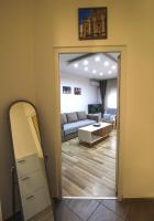 a living room with a mirror and a couch at TOP Apartman in Šabac