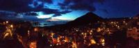 a view of a city at night with a mountain at TopHome 9 in Jiufen