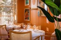 a dining room with two tables with wine glasses at Roslin Beach Hotel in Southend-on-Sea