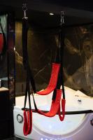 a pair of red high heels hanging from hooks at Capsule Secret - Jacuzzi - Netflix &amp; Home cinéma - Jeux de couple - Barre de pole dance in Valenciennes