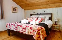 a bedroom with a large bed and a wooden ceiling at Chalet Falcon With Hot Tub - in a great location! in Chamonix