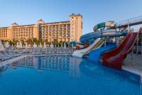 a pool with a water slide in front of a hotel at Lake River Side Hotel Spa in Side