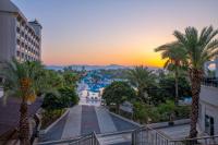 a view of a resort at sunset with palm trees at Lake River Side Hotel Spa in Side