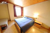 Łóżko lub łóżka w pokoju w obiekcie Appartamento MilHouse by Livigno Accomodation