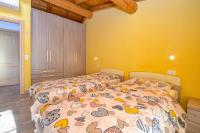 A bed or beds in a room at Casa nel Borgo - Il Gufo