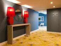 a room with a mirror and a table with a lamp at Lutecia Smart Design Hotel in Lisbon
