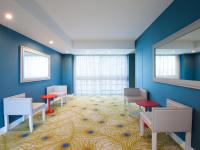 a waiting room with blue walls and red chairs at Lutecia Smart Design Hotel in Lisbon