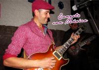 a man playing a guitar while wearing a red hat at Union Hotel Cusco in Cusco