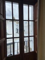 an open window with a view of a building at Hotel Tugasa Convento San Francisco in Vejer de la Frontera