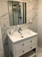 a bathroom with a white sink and a mirror at Sainte Cécile 6 &#47; Studio Elégant et Central in Vichy