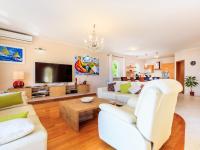 a living room with white furniture and a flat screen tv at Holiday Home Villa Orhidea by Interhome in (( Marčići ))