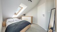 Posteľ alebo postele v izbe v ubytovaní Apartamenty Sun & Snow Baltic Sun z basenem i placem zabaw