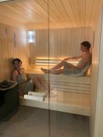 two women are sitting in a sauna at Manoir de Malagorse in Cuzance