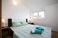 Postel nebo postele na pokoji v ubytování Apartments Jakoplić