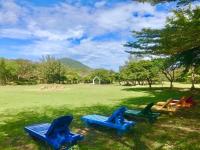 a group of blue chairs sitting in a field at Kenting Tuscany Resort in Kenting