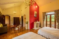 a bedroom with red walls and a bed and a fireplace at Kenting Tuscany Resort in Kenting