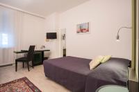 A bed or beds in a room at Hotel Buonconsiglio