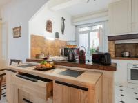 a kitchen with a counter with a bowl of fruit on it at Holiday Home La Maison Theaulon by Interhome in Aigues-Mortes