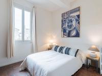 a white bedroom with a bed and a window at Holiday Home La Maison Theaulon by Interhome in Aigues-Mortes