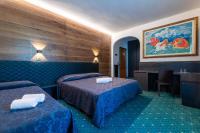 Posteľ alebo postele v izbe v ubytovaní Hotel La Perla