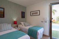 A bed or beds in a room at Par 4 Blue Star by VillaGranCanaria